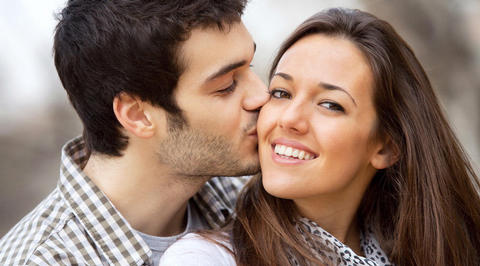 Man kissing woman on the cheek