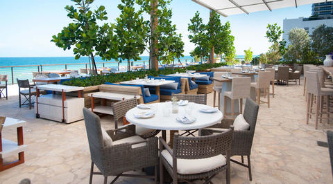 Outdoor restaurant seating area overlooking the ocean